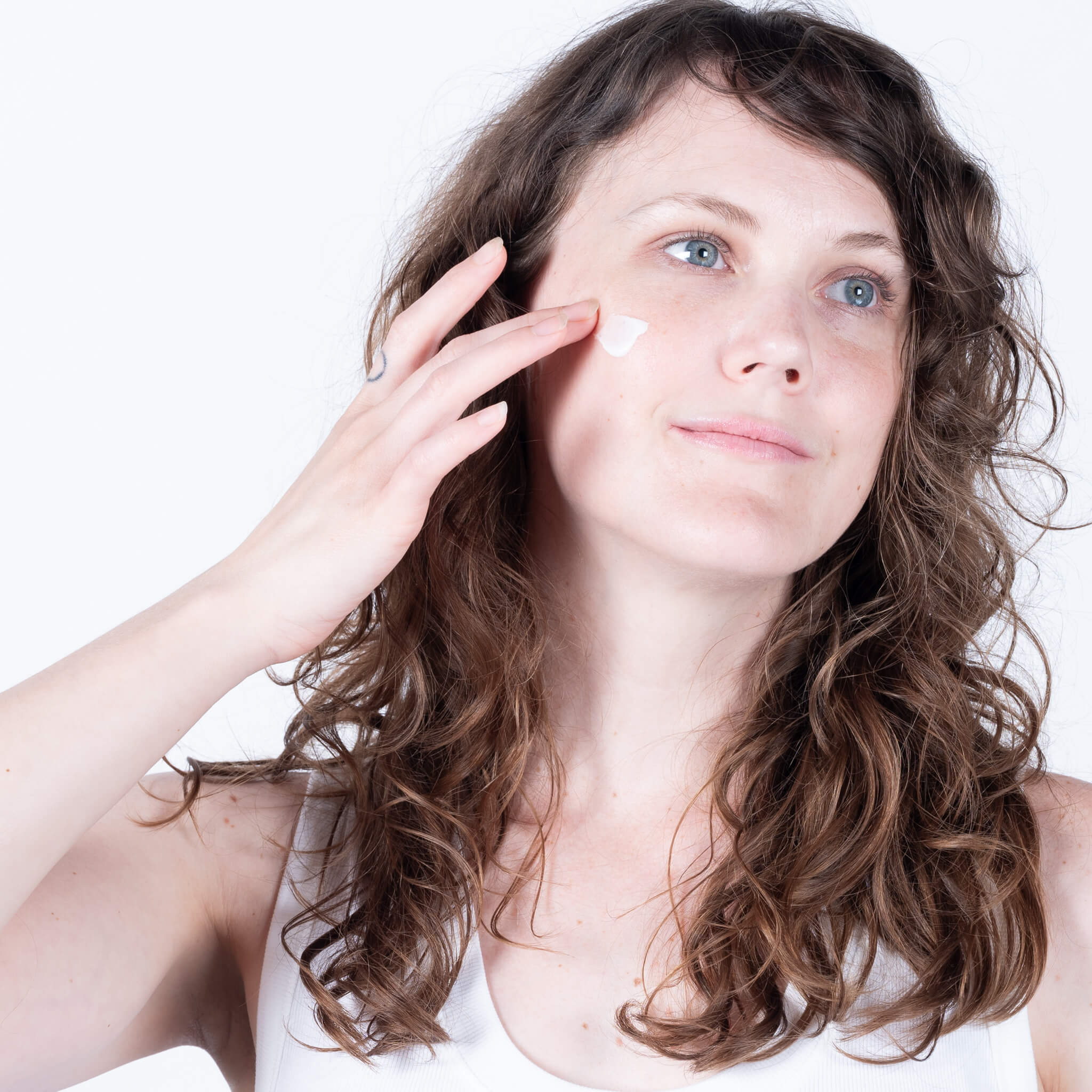 Stephanie applying all natural vegan face cream.