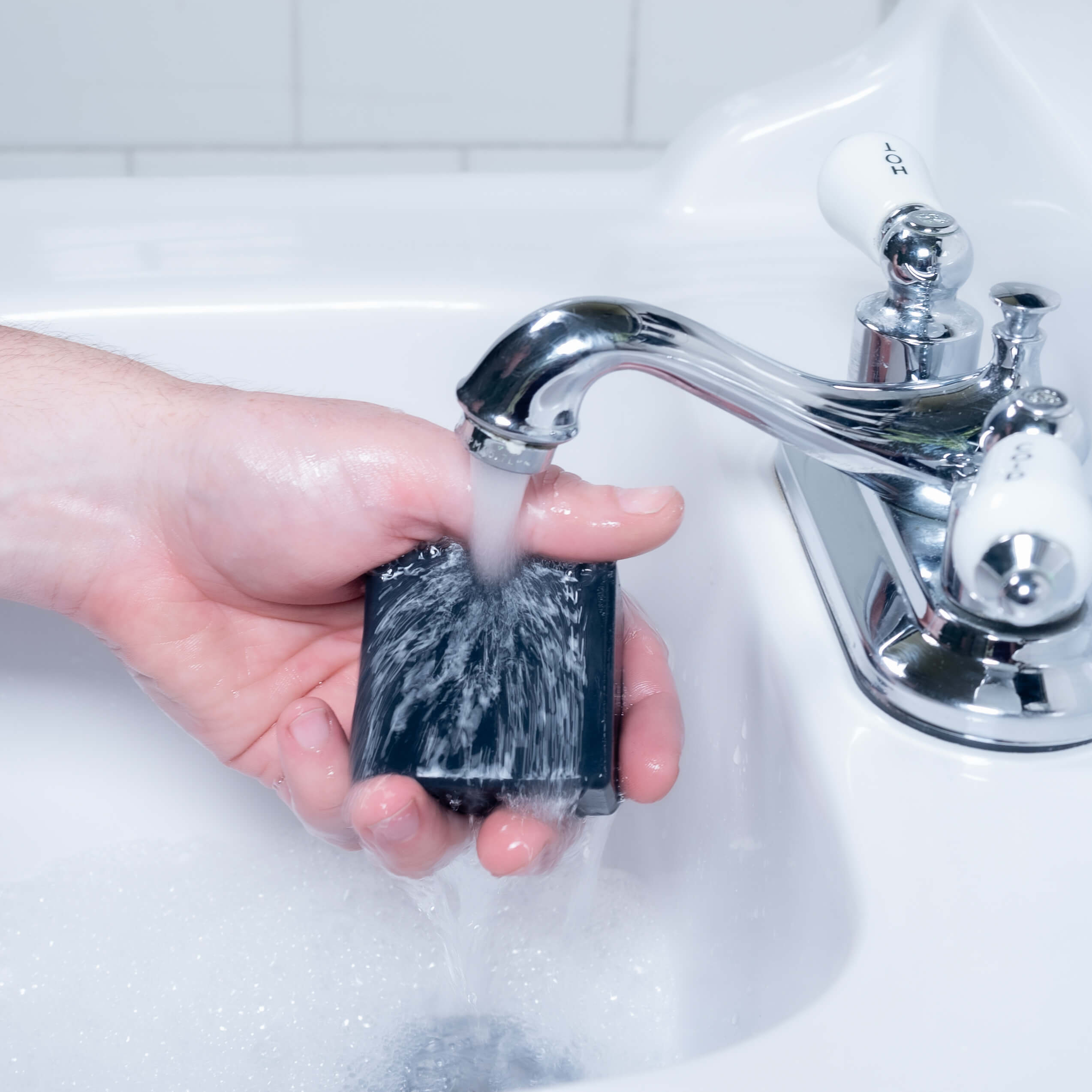 Jeff washing up with an all natural zero-waste charcoal bar soap.
