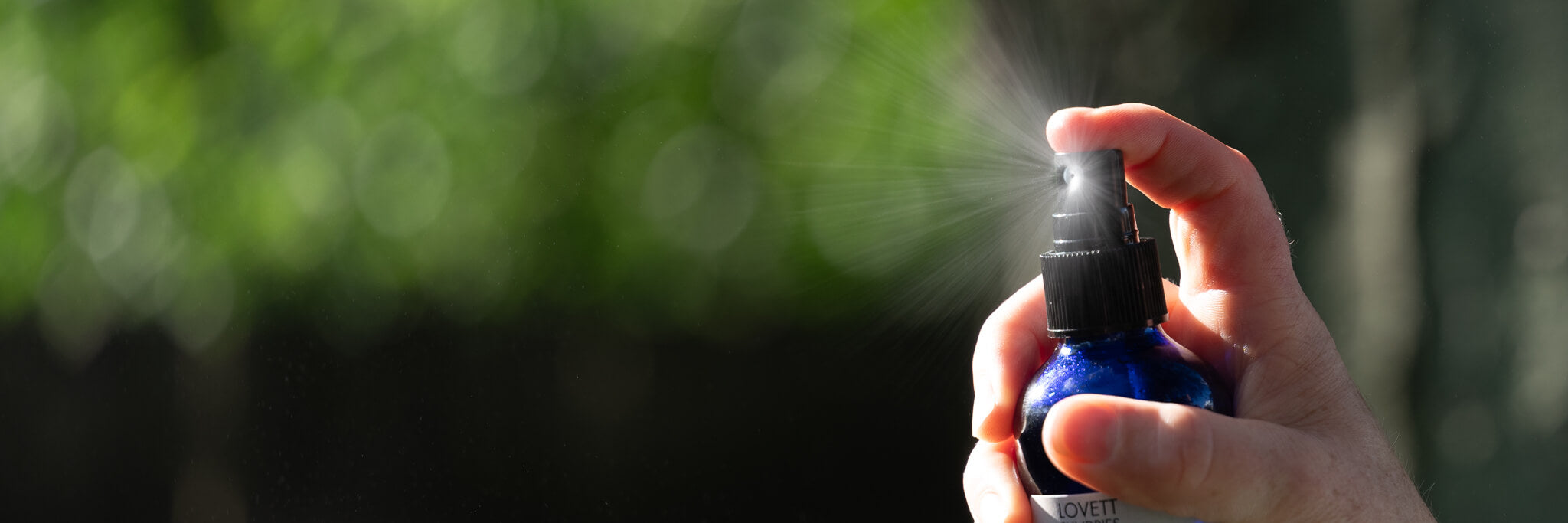 Marit spritzing cooling mist in the sunny back yard.