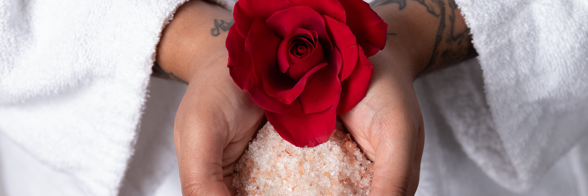 Tati holding all natural vegan soaking salts and a rose.