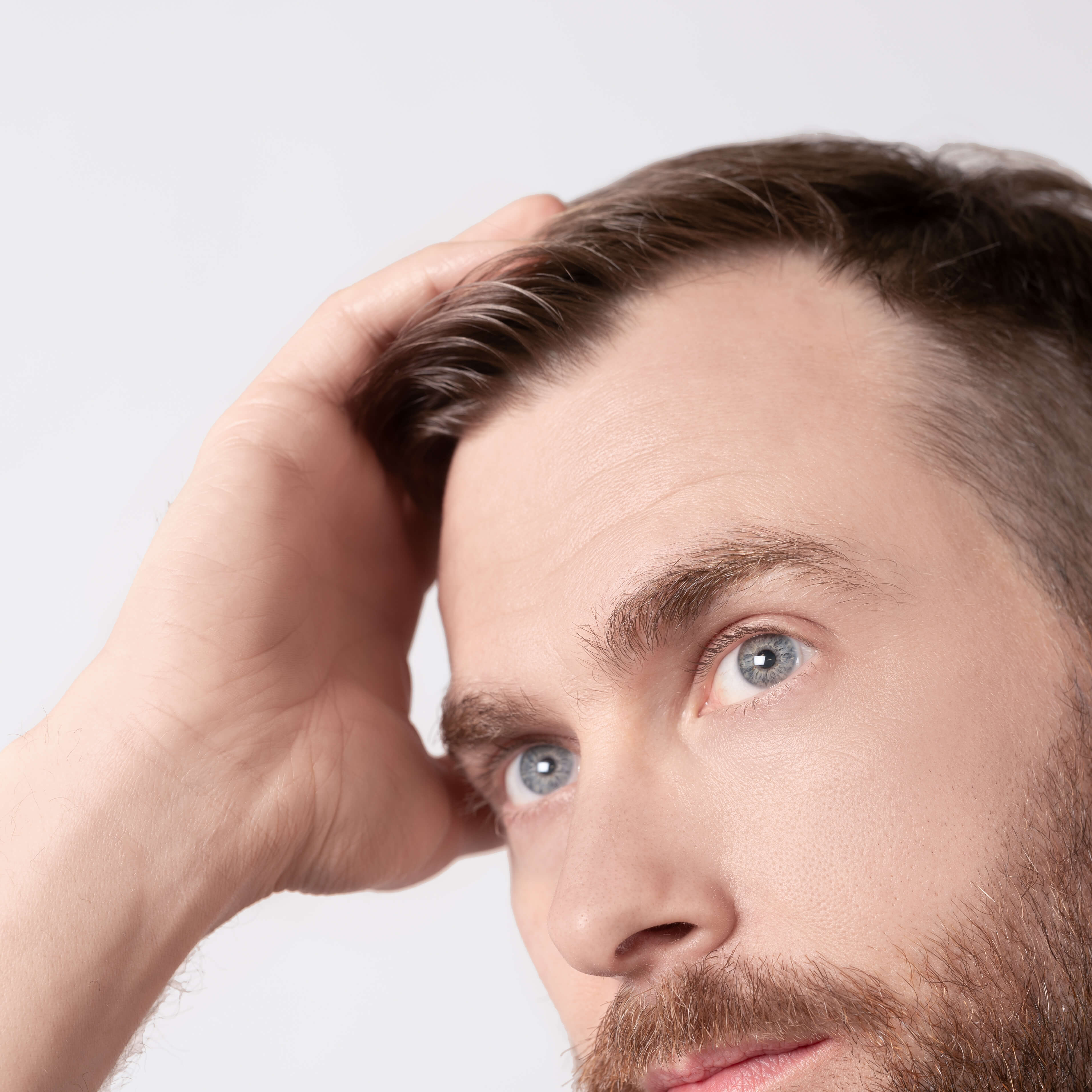 John working an all natural zero waste styling cream pomade through his hair.