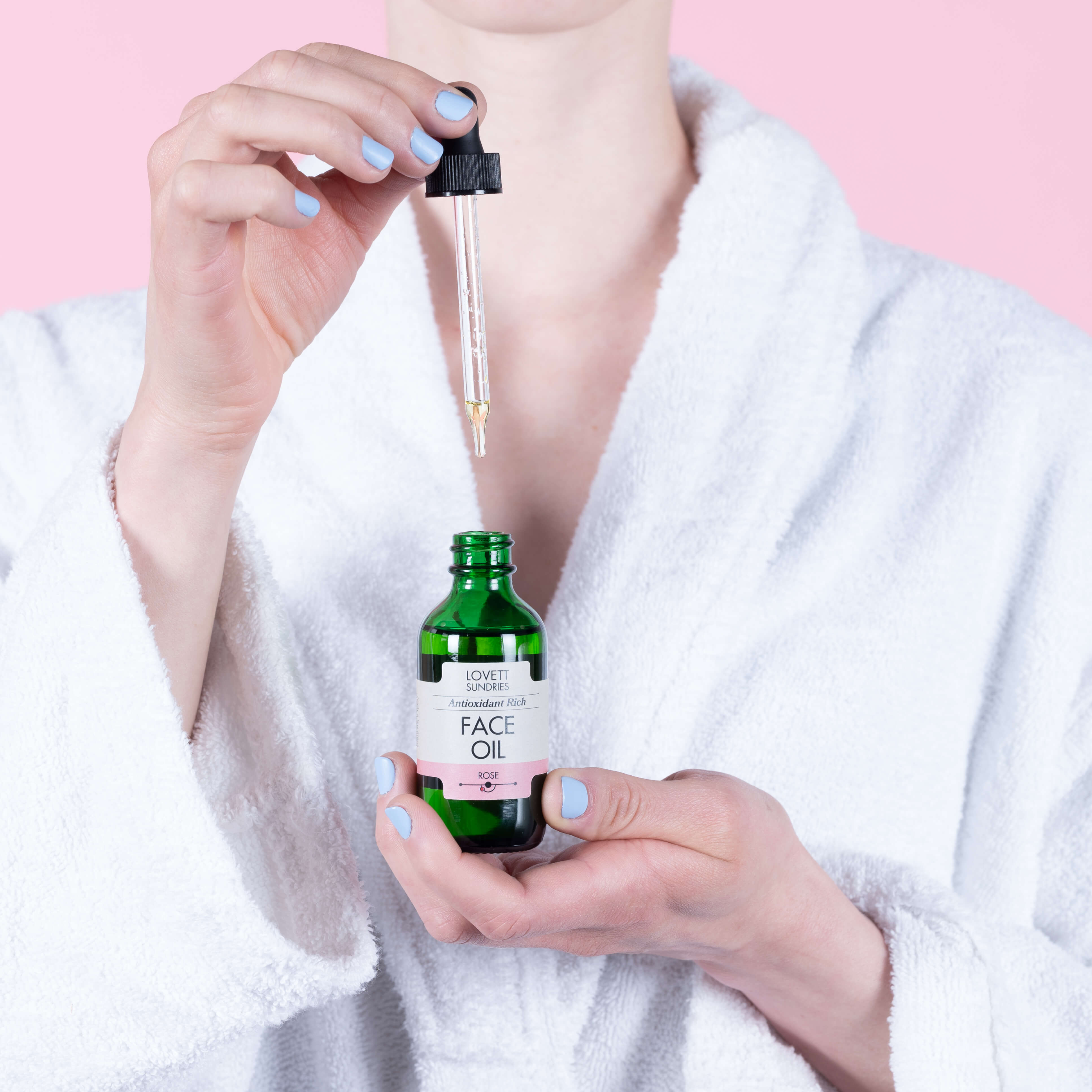 Kari dripping all natural face oil back into the bottle.