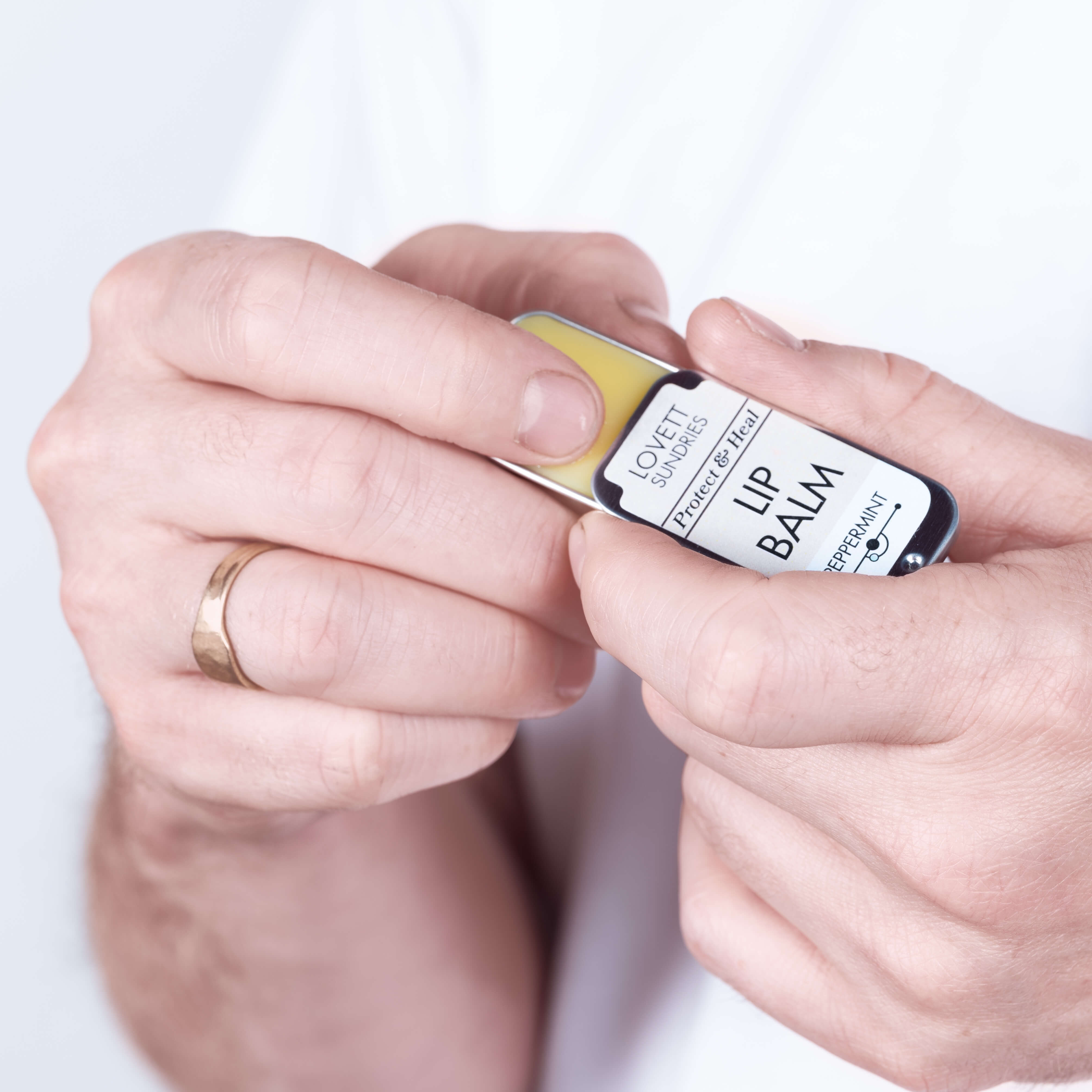 John using some all natural peppermint lip balm in a zero waste tin.