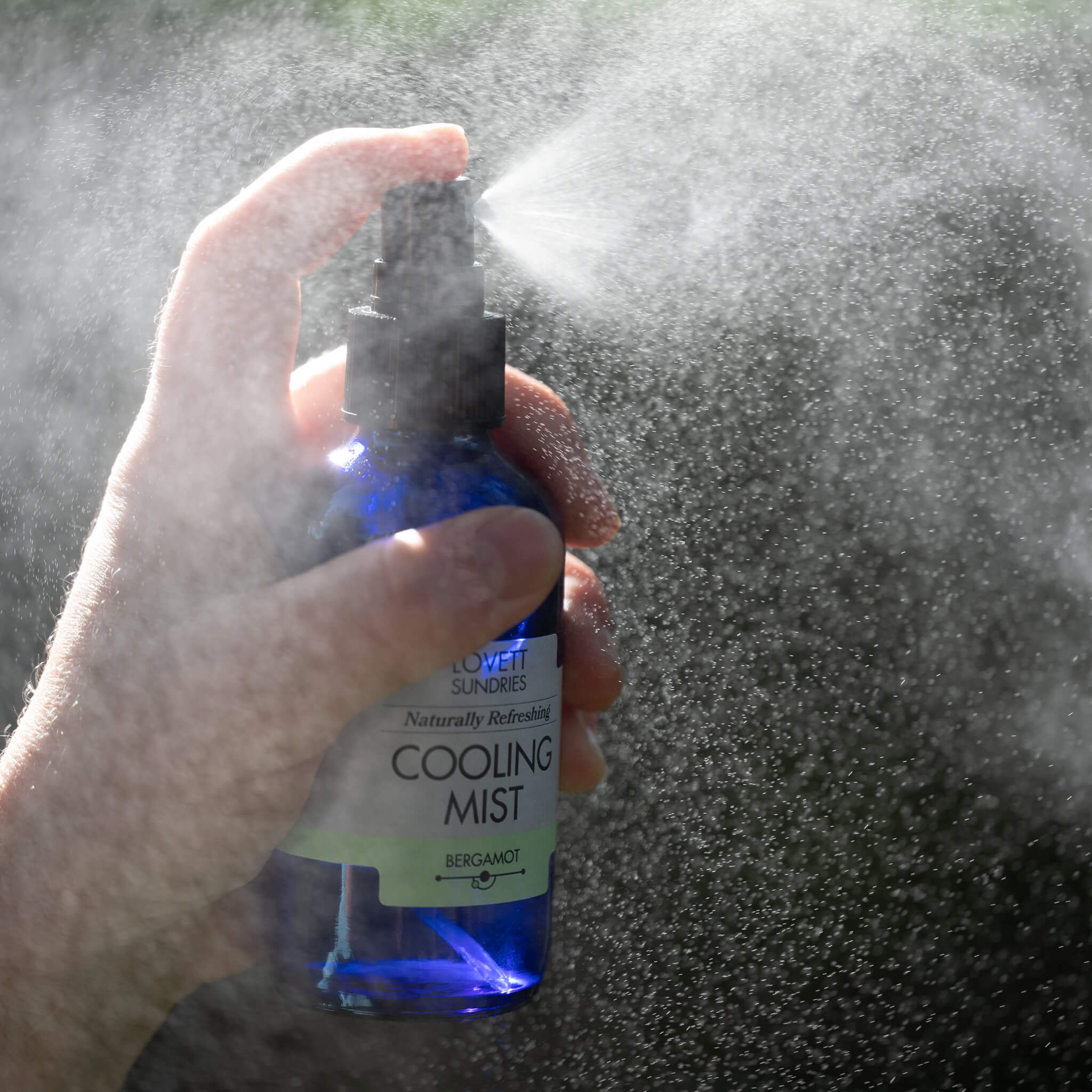 A beautiful cool mist spritzing from the bottle.