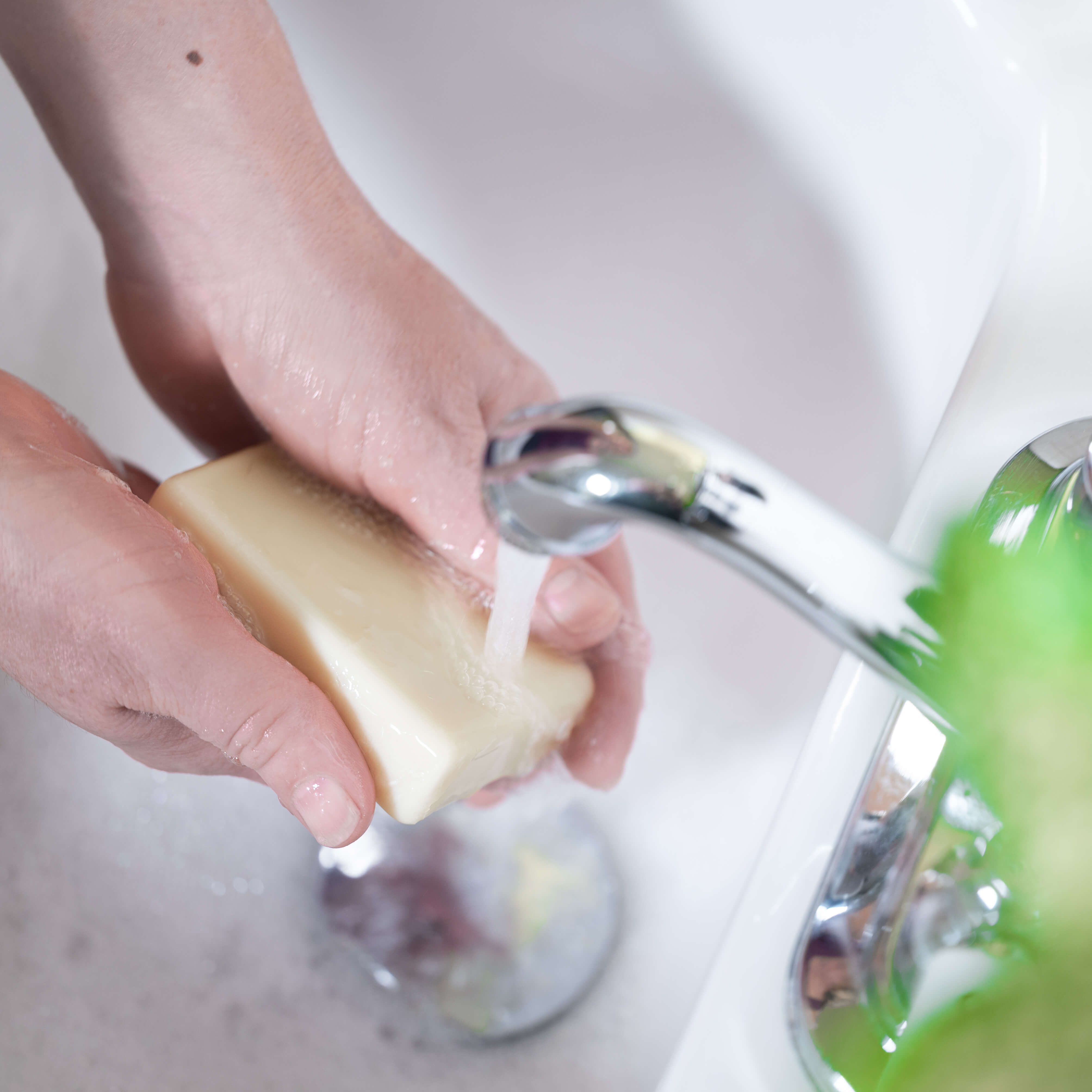 Marit washing her hands with an all natural zero waste Pure Olive Oil Soap in a vintage white sink.