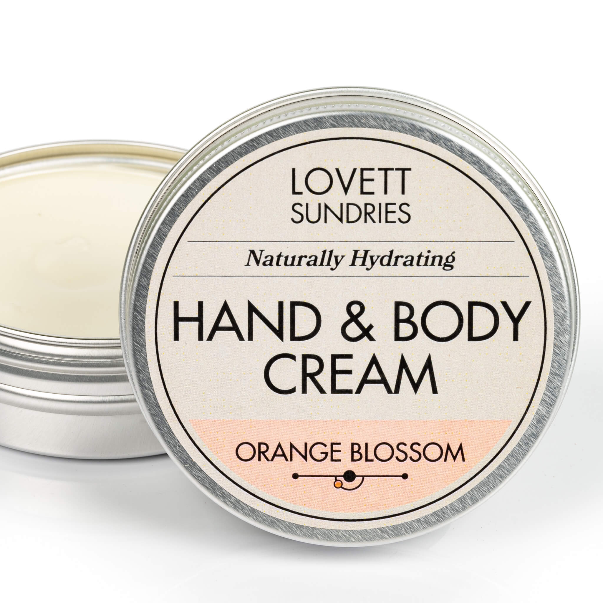 Open tin of creamy all natural hydrating orange blossom scented hand and body cream.