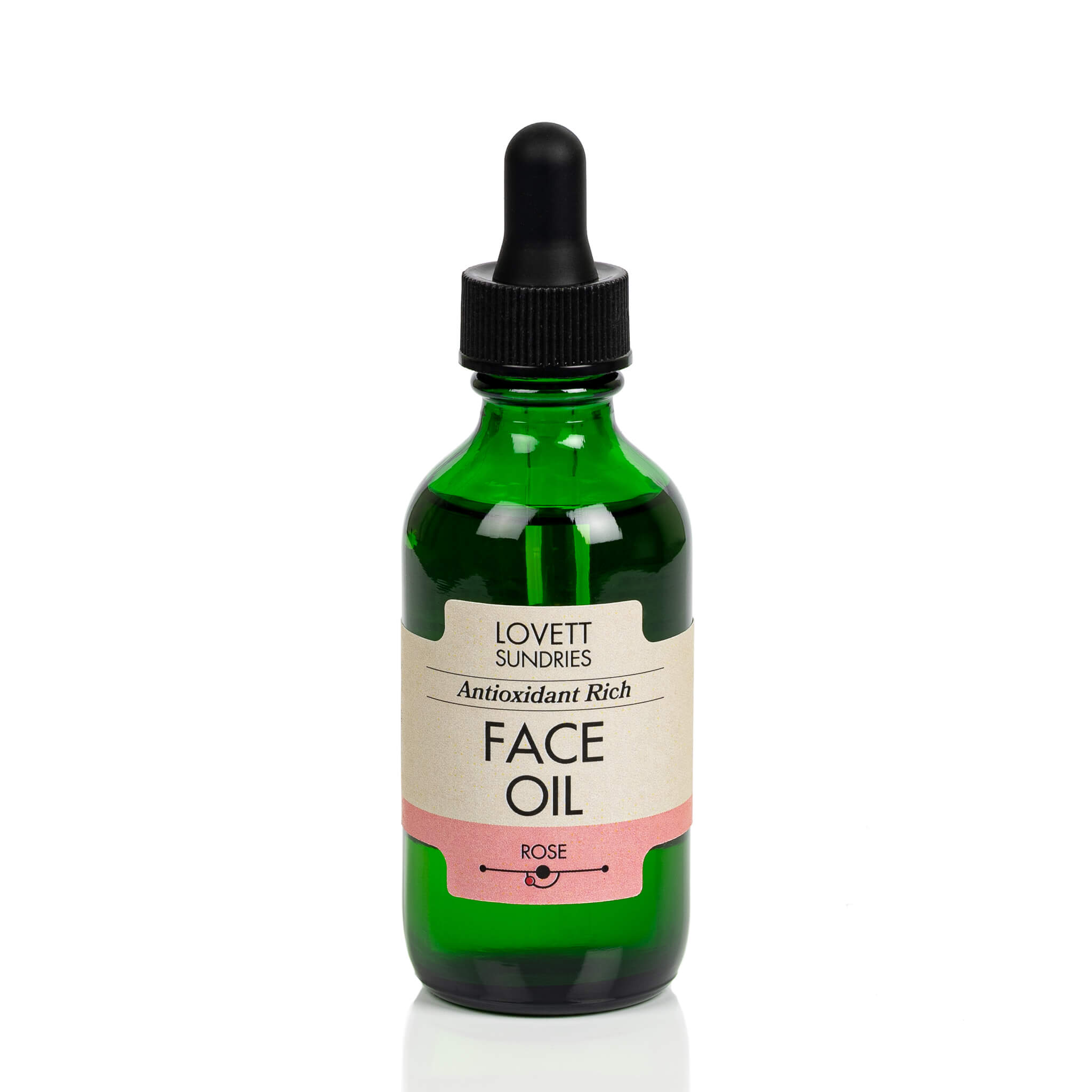 All natural antioxidant rich rose scented face oil in a green glass jar with a dropper. 