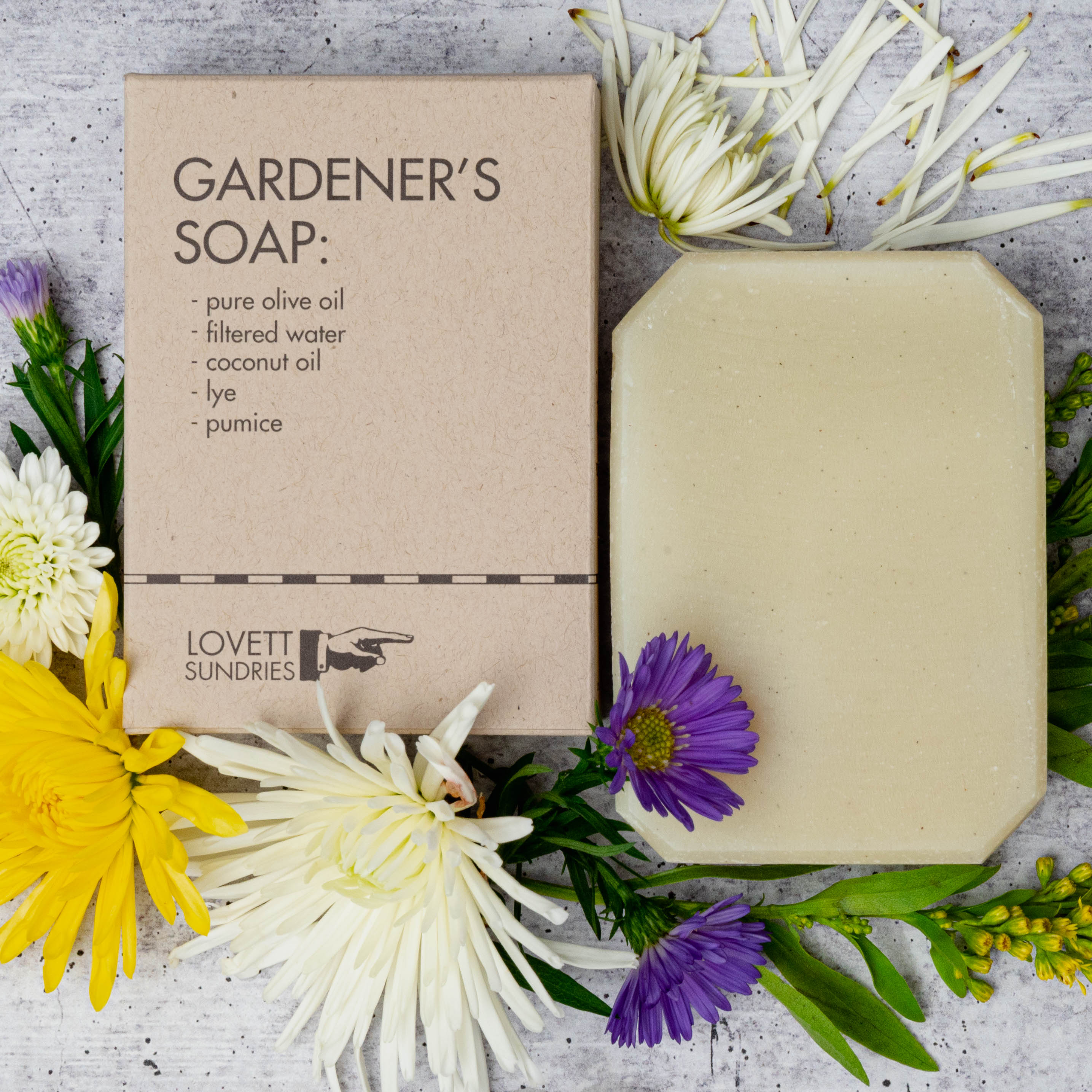 Box of Gardener's Soap surrounded by flowers.