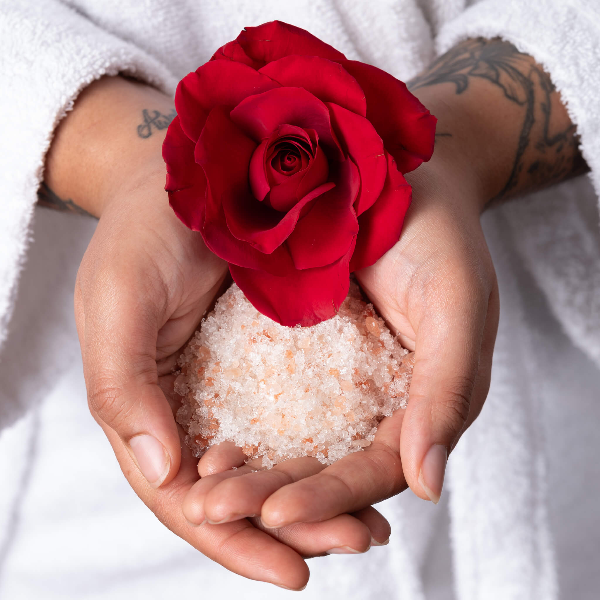 Tati holding all natural vegan soaking salts and a rose.