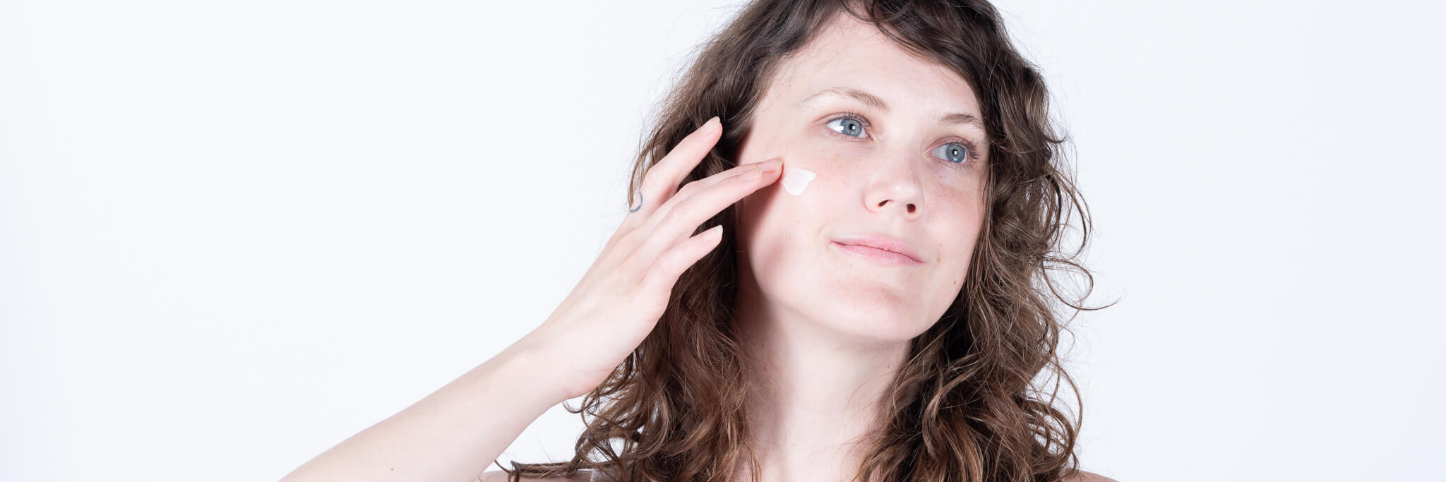 Stephanie applying all natural vegan face cream. 