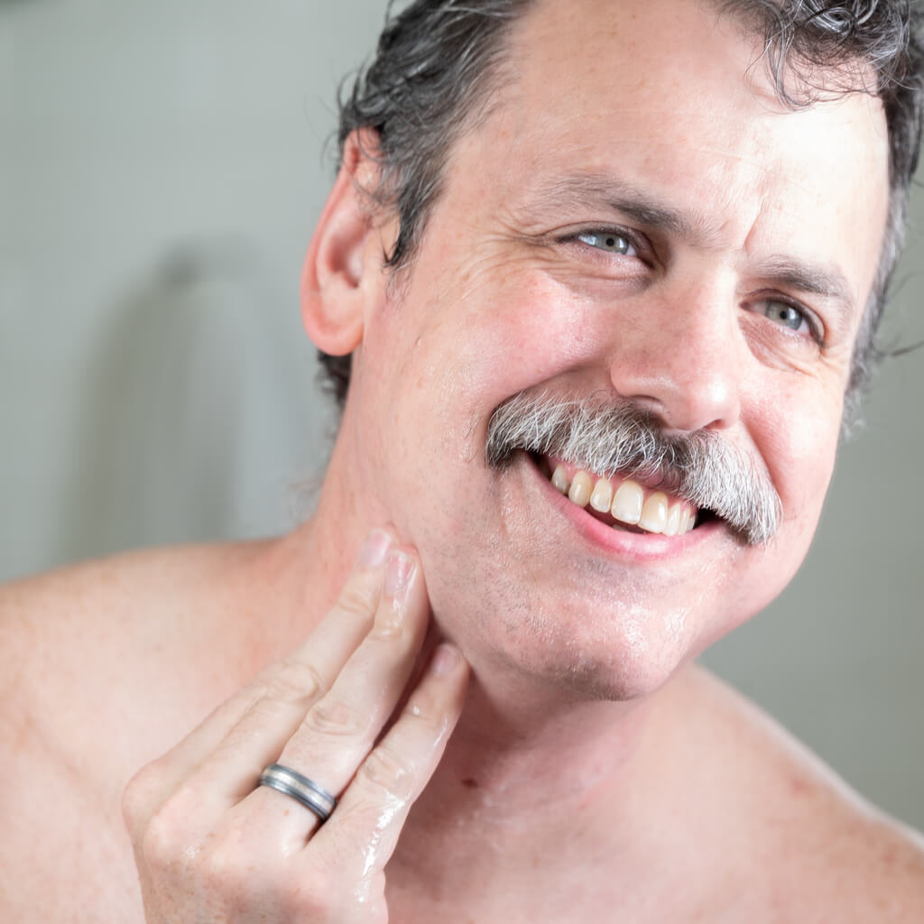 Jeff moisturizing with aftershave balm after shaving.