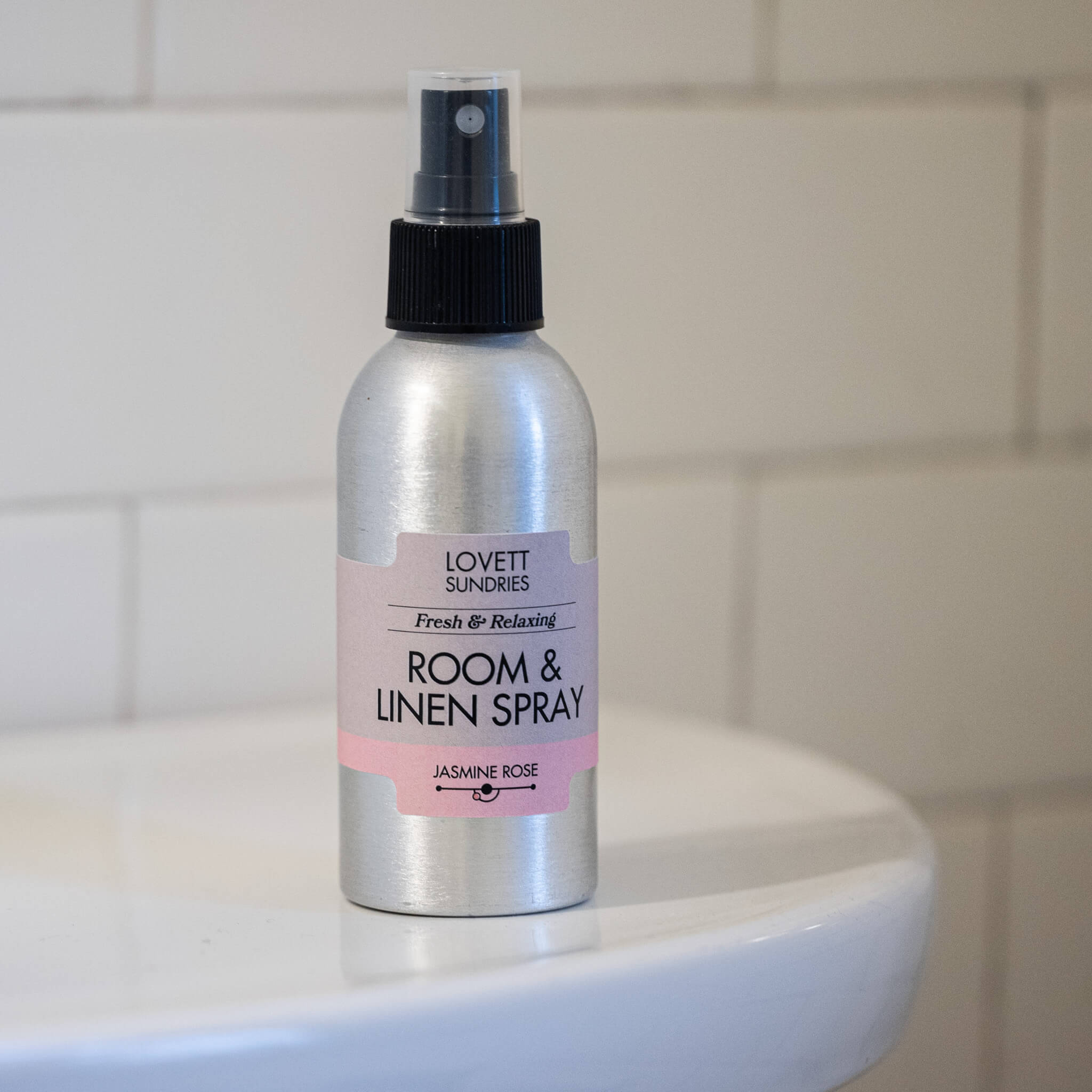 All natural room & linen spray on a white counter in the bathroom.