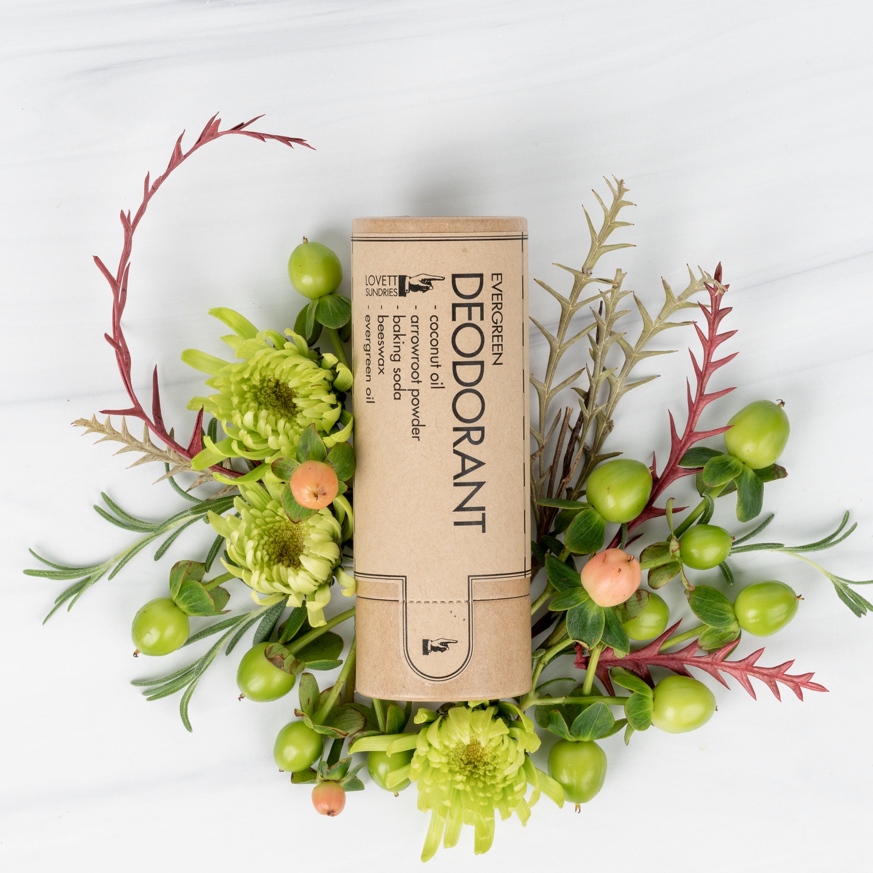 evergreen-scented aluminum-free deodorant surrounded by fresh flowers.