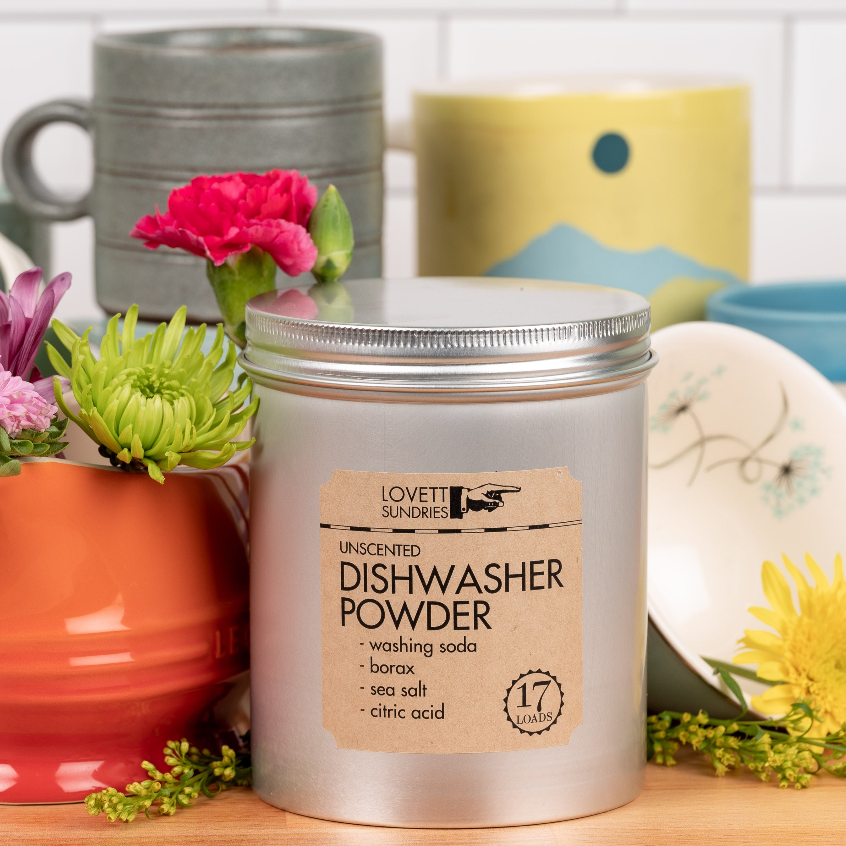 A tin of unscented all-natural dishwasher detergent powder.