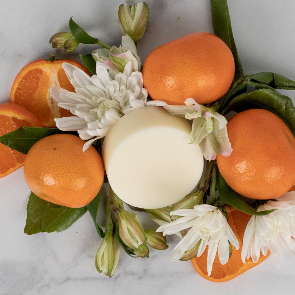 A conditioner bar surrounded by oranges and flowers.