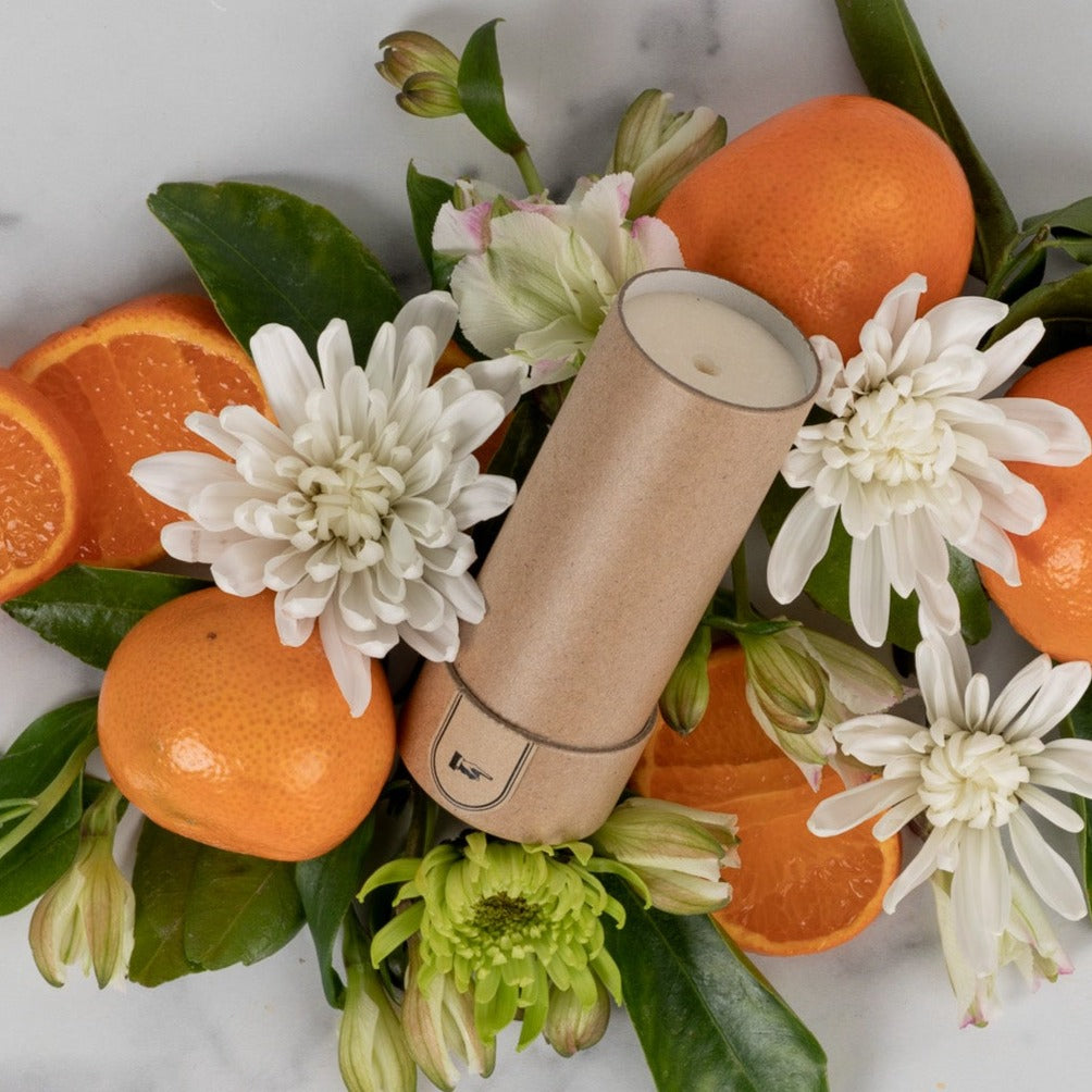 aluminum-free deodorant surrounded by oranges.